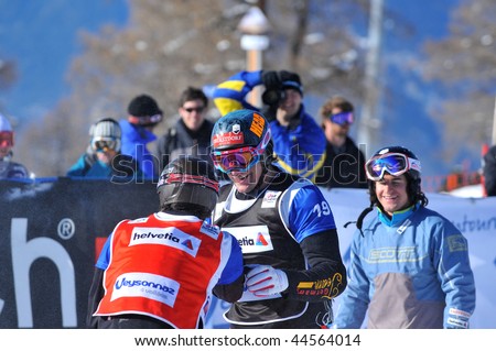 VEYSONNAZ, SWITZERLAND - JANUARY 15:  FIS World Championship Snowboard Cross finals. New world champion Pierre Vaultier congratulates 2nd David Speiser.  January 15 in Veysonnaz, Switzerland