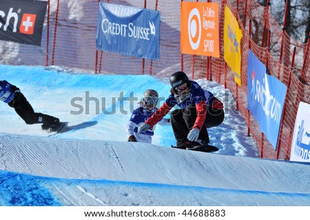 VEYSONNAZ, SWITZERLAND - JANUARY 15:  FIS World Championship Snowboard Cross finals. New world champion Olafsen leads Simona Meiler on January 15, 2010 in Veysonnaz, Switzerland