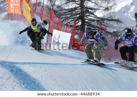 VEYSONNAZ, SWITZERLAND - JANUARY 15:  FIS World Championship Snowboard Cross finals. Francois Bonvin 4th place in the world cup leads the pack on January 15, 2010 in Veysonnaz, Switzerland
