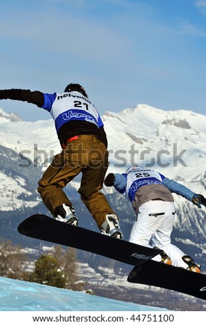 VEYSONNAZ, SWITZERLAND - JANUARY 15: World championship Snowboard cross  finals. Swiss Caduff leads Reichen over the jump.  January 15 in Veysonnaz, Switzerland.