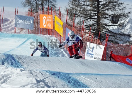 VEYSONNAZ, SWITZERLAND - JANUARY 15: World championship Snowboard cross  finals. Nick Baumgartner usa leads Patrick Holland of the USA. January 15 in Veysonnaz, Switzerland.