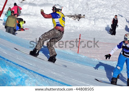 VEYSONNAZ, SWITZERLAND - JANUARY 15: World championship Snowboard cross  finals. Tanja Firieden approaches the big jump. January 15 in Veysonnaz, Switzerland.