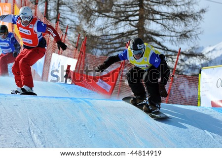 VEYSONNAZ, SWITZERLAND - JANUARY 15: World championship Snowboard cross  finals. Xavier de le Rue leads nick Baumgartner  in the finals. January 15 in Veysonnaz, Switzerland.