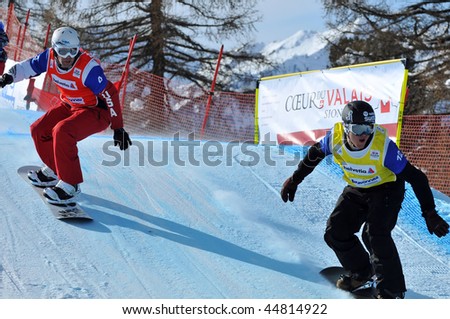 VEYSONNAZ, SWITZERLAND - JANUARY 15: World championship Snowboard cross  finals. xavier de le Rue leads Nick Baumgartner. January 15 in Veysonnaz, Switzerland.