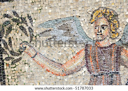 An angel offers a lawrel crown to a king. Part of the UNESCO listed mosaic floor of the basilica of Aquileia in Italy.