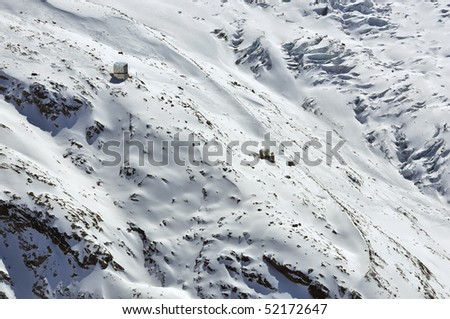 The monte Rosa (mont rose) hut for climbers, both new and old ones in the winter. On the flanks of the Monte Rosa in the southern swiss alps above Zermatt