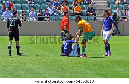 SION, SWITZERLAND- JUNE 4: Fair play from Drogba of Ivory Coast in a friendly match against Japan for the 2010 world cup:  June 4, 2010 in Sion Switzerland