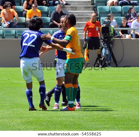 SION, SWITZERLAND - JUNE 4: Nakazawa helped by Drogba of Ivory Coast in a friendly match against Japan for the 2010 world cup:  June 4, 2010 in Sion Switzerland