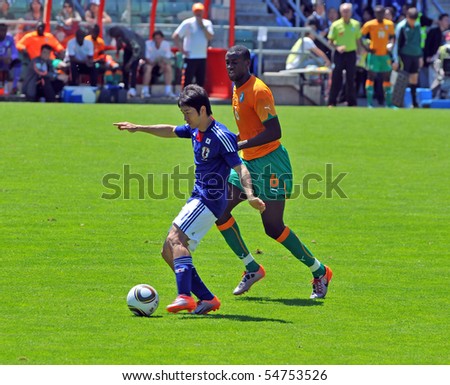 SION, SWITZERLAND - JUNE 4: Toure (6) of Ivory Coast in a friendly match against Japan for the 2010 world cup shadows Tamada:  June 4, 2010 in Sion Switzerland