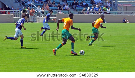 SION, SWITZERLAND - JUNE 4: Soulemane Samba runs with the ball for the Ivory Coast in a friendly match against Japan for the 2010 world cup:  June 4, 2010 in Sion Switzerland
