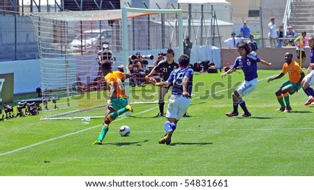 SION, SWITZERLAND - JUNE 4: Salomon Kalou of Ivory Coast attacking in a friendly match against Japan for the 2010 world cup. Konno and Nakazawa defending:  June 4, 2010 in Sion Switzerland
