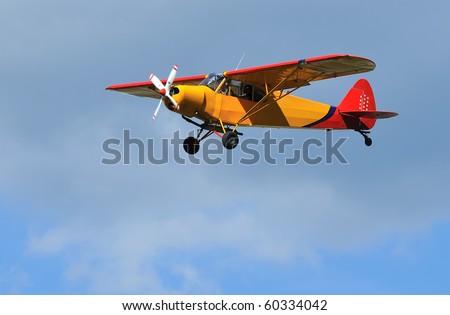 light 2-seater aircraft coming in to land. Piper Super Cub, ideal for short take off and landing STOL