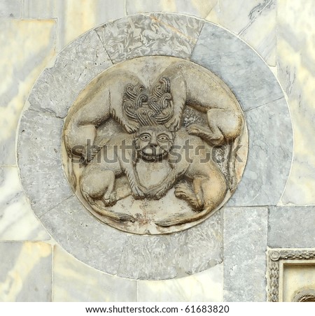 byzantine mythical creature with four bodies sharing a single head, executed in marble in a marble lunette. From the wall of St Mark\'s basilica in Venice