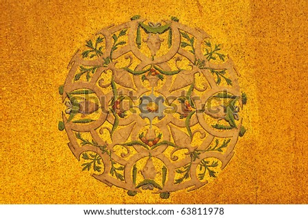 symmetric circular pattern of vases and flowers executed in gold mosaics by a venetian artist. On the basilica of Saint Mark, Venice, Italy.