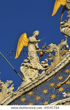 golden winged angels on the facade of the basilica of saint mark, Venice, Italy.