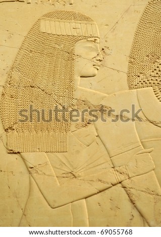 bas-relief of a pretty woman with frizzy hair cut in limestone from the Tomb of Ramose in the ancient egyptian necropolis of the nobles at thebes near Luxor, Egypt
