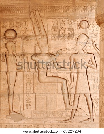 the ancient egyptian god of the underworld, Osiris, giving the gift of eternal life to Ramses II at the Ramesseum, Luxor, Egypt