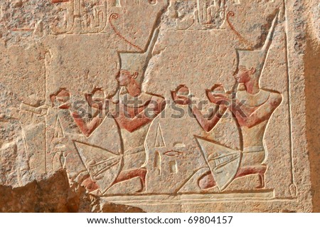 Pharaoh  wearing the white crown of upper Egypt and making offerings to the god