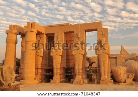 stock-photo-line-of-giant-osiris-statues-at-the-ramesseum-the-ancient-egyptian-mortuary-temple-of-ramses-ii-at-71048347.jpg