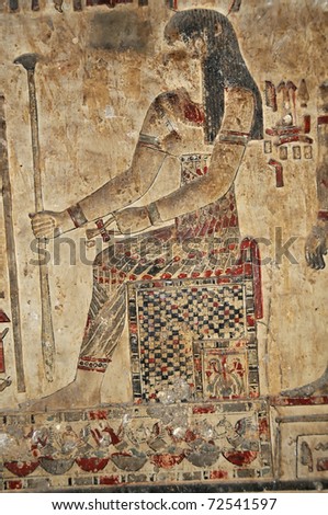 hidden underground painted bas relief probably of the love goddess hathor wearing a beautiful feather like skirt with leggings  under the ancient Egyptian  temple of the goddess Hathor at Dendera