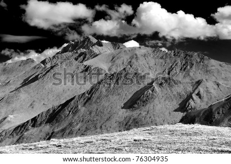 Monochrome of dry mountains on the italian swiss border where the tour de mont blanc crosses from switzerland into italy