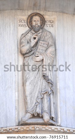 Byzantine marble sculpture of the evangelist Saint John, on the wall of Saint Mark\'s basilica, Venice, Italy