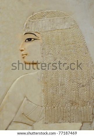 Exquisite bas-relief portrait of proud and beautiful and bare chested young woman with frizzy hair from the Tomb of Ramose in the ancient egyptian necropolis of the nobles at thebes near Luxor, Egypt