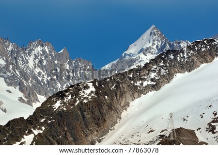 The sharp alpine summit of Mont Dolent (3823m) in the Mont Blanc massif marks the meeting point of France, Italy and Switzerland.