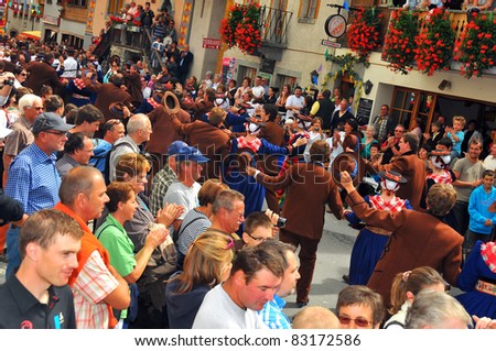 EVOLENE, SWITZERLAND - AUGUST 15: Swiss dancers in the crowd at the International Festival of Folklore and Dance from the mountains (CIME) : August 15, 2011 in Evolene Switzerland