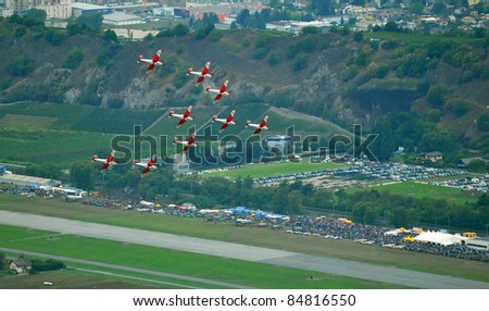 SION, SWITZERLAND - SEPTEMBER 17: Swiss Air Force PC-7 team performing over spectators at the Breitling Air show.  September 17, 2011 in Sion, Switzerland