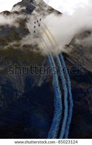 SION, SWITZERLAND - SEPTEMBER 18: Breitling display team climbing steeply in the mountains at the Breitling Air show.  September 18, 2011 in Sion, Switzerland