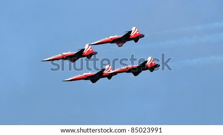 SION, SWITZERLAND - SEPTEMBER 18: Swiss Air Force team in formation in a blue sky at the Breitling Air show.  September 18, 2011 in Sion, Switzerland