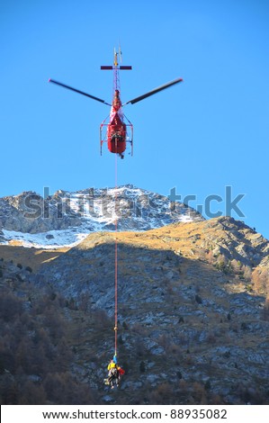 Helicopter search and rescue, carrying a climber to safety after a climbing accident