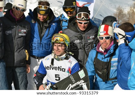 VEYSONNAZ, SWITZERLAND - JANUARY 23: Italian world cup team with (no 5) E. Perathoner (bronze medal winner) in the FIS World Championship Snowboard Cross finals on January 23, 2012 in Veysonnaz, Switzerland