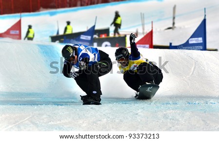 VEYSONNAZ, SWITZERLAND - JANUARY 22: Nate Holland (USA) beats Markus Schairer (GER) in the final of the FIS World Championship Snowboard Cross finals : January 22, 2012 in Veysonnaz Switzerland