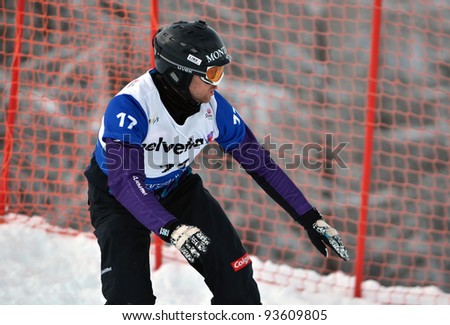 VEYSONNAZ, SWITZERLAND - JANUARY 21: Silver medalist Markus Schairer (AUT) competes in the FIS World Championship Snowboard Cross finals on January 21, 2012 in Veysonnaz, Switzerland