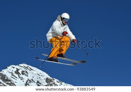 A Freerider On Skis In White And Orange Perfo
