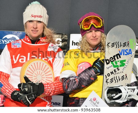 VEYSONNAZ, SWITZERLAND - JANUARY 22: Left silver for D Maltais (CAN) and gold for L Jacobellis (USA) at the FIS World Championship Snowboard Cross finals on January 22, 2012 in Veysonnaz, Switzerland