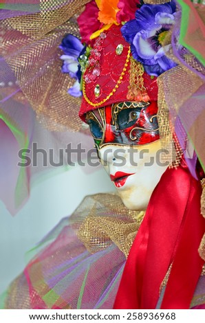 VENICE, ITALY - FEBRUARY 12: Beautiful Carnival masked lady in tones of red at the 2015 Venice Carnival:  February  12, 2015 in Venice, Italy