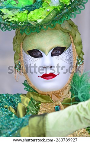 VENICE, ITALY - FEBRUARY 12: Green floral carnival costumed girl at the 2015 Venice Carnival:  February  12, 2015 in Venice, Italy