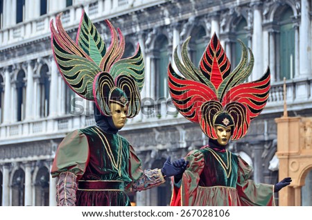 VENICE, ITALY - FEBRUARY 12: Matching carnival couple in St Marks Square the 2015 Venice Carnival:  February  12, 2015 in Venice, Italy