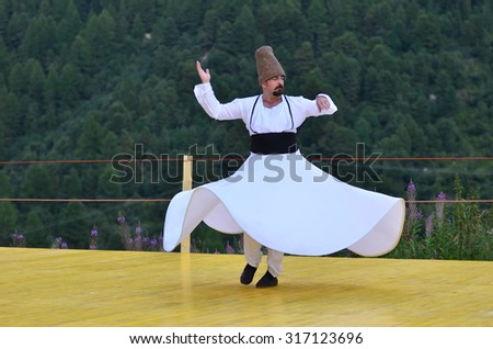 AROLLA, SWITZERLAND - AUGUST 12: Whirling Dervish from Bozdaglar in the CIME mountain culture Festival: August 12, 2015 in Arolla, Switzerland