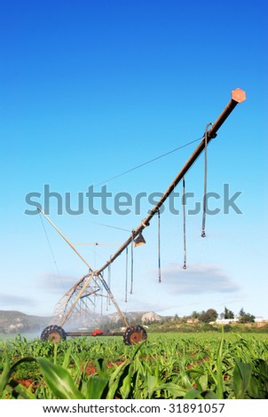 Modern irrigation pivot system watering a farm land