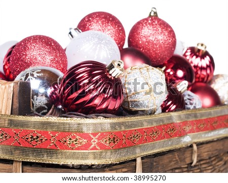 Red and silver christmas decorations on a white background with space for text