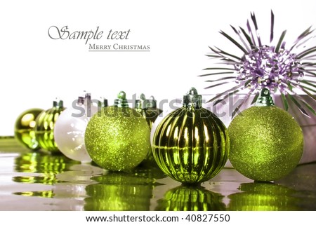 Green and silver christmas baubles against white background with space for text