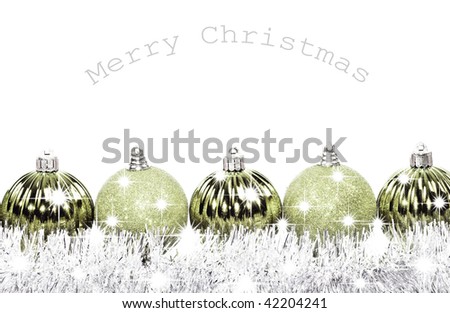 Silver christmas baubles against a white background with space for text
