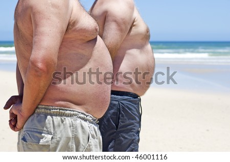 Two very fat men on the beach