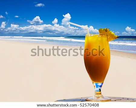 A fresh fruit cocktail on a tropical island beach