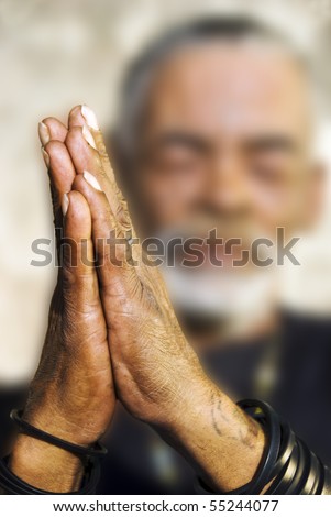 An old African man with folded hands - focus on the weathered hands