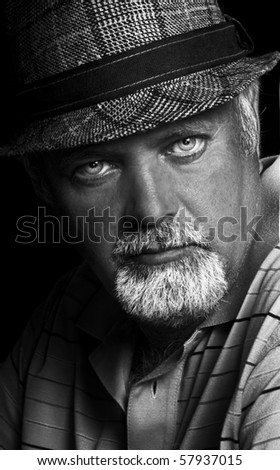 Black and white low light portrait of a middle aged man